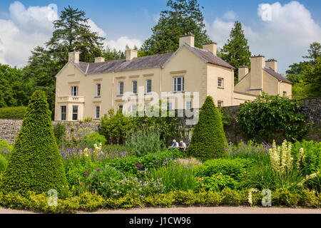 Two visitors sitting in the Upper Walled Garden at Aberglasney House and Gardens,Llangathen, Carmarthenshire, Wales, UK Stock Photo