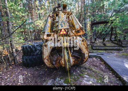 Radioactive scrap bucket in Pripyat city of Chernobyl Nuclear Power Plant Zone of Alienation around the nuclear reactor disaster in Ukraine Stock Photo