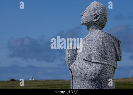 A statue of Saint Colmcille (St Columba) outside St Colmcilles Church (Teach Pobail Cholmcille Naofa) on Tory Island Stock Photo