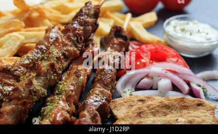 Grilled meat skewers and fried potatoes Stock Photo