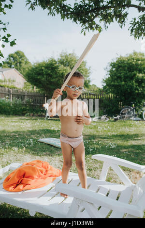 young coloured boy is having fun on the swing Stock Photo