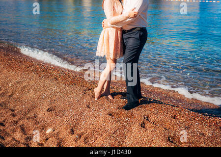 Women's and men's feet in the sand Stock Photo