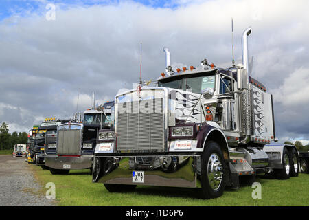 ALAHARMA, FINLAND - AUGUST 12, 2016: Classic Kenworth W900B and other show trucks on display under dramatic sky on the annual trucking event Power Tru Stock Photo