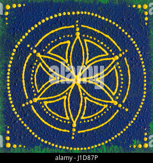 Hand painted mandala with yellow green and blue colours on a piece of square wood. Stock Photo