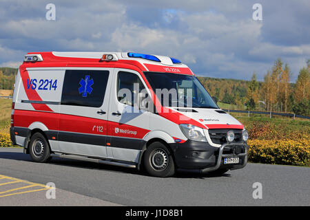 SALO, FINLAND - SEPTEMBER 18, 2016: Ambulance gets an emergency call and rushes ahead along road on a sunny autumn day in South of Finland. Stock Photo