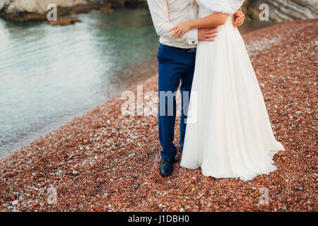 Women's and men's feet in the sand Stock Photo