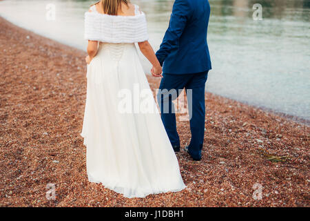 Women's and men's feet in the sand Stock Photo