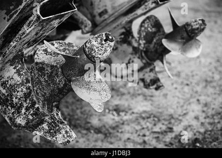 Old rusted propeller screws, grungy black and white photo Stock Photo