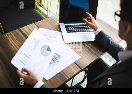 Close-up of male hand making notes in office Stock Photo