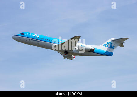 AMSTERDAM - APRIL 21, 2015: KLM Cityhopper Fokker F70 aircraft taking off from Schiphol airport. Stock Photo