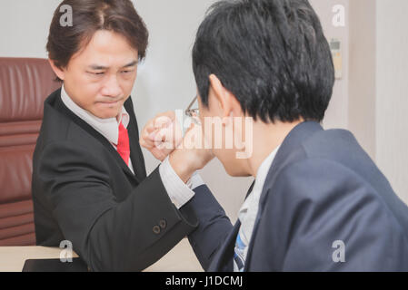 Two Businessman Competing In Arm Wrestling, Competition concept Stock Photo