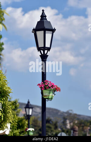 Lampost with flowers in Nafplio town, Peloponnese, Greece Stock Photo