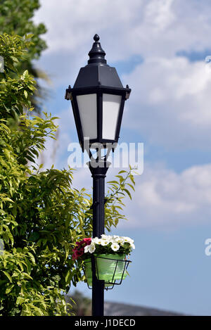 Lampost with flowers in Nafplio town, Peloponnese, Greece Stock Photo
