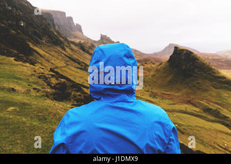 Man standing in the rain at Quiraing, Isle of Skye, Scotland Stock Photo