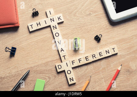 Think different concept of crossword puzzle on wooden surface or Stock Photo