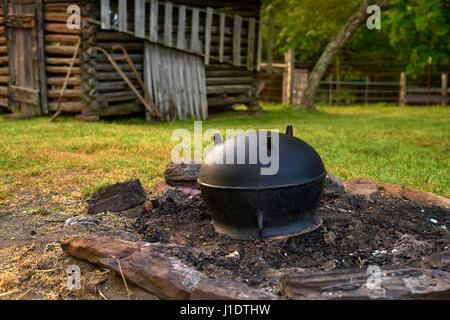 Cooking over an open fire in a cast iron pot used to be the standard, but that has given away to much more modern technology today. Stock Photo
