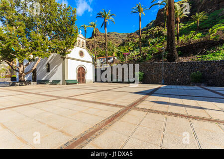 Typical church on square with palm trees in Valle Gran Rey village on La Gomera island, Spain Stock Photo