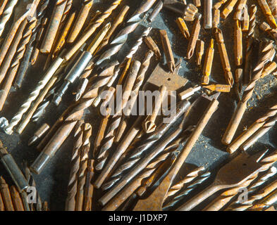 Sun shining through workshop window on assorted drill bits Stock Photo