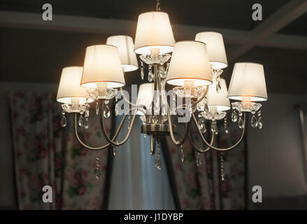 Beautiful luxurious chandelier in the hall Stock Photo