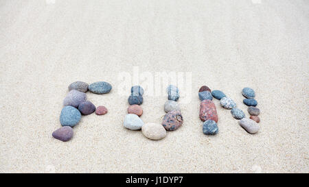 Fun word made of pebbles on a sandy beach. Stock Photo