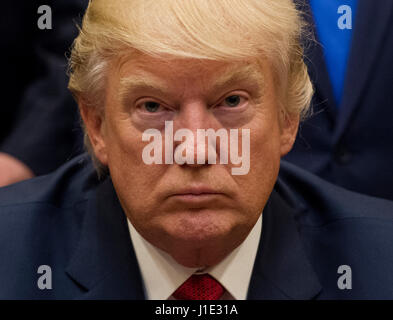 Washington, USA. 19th Apr, 2017. United States President Donald Trump listens after signing the S. 544 the Veterans Choice Program Extension and Improvement Act in the Roosevelt Room at the White HoUSAe in Washington, DC on April 19, 2017. Photo: Molly Riley/Consolidated/Pool/dpa/Alamy Live News Stock Photo