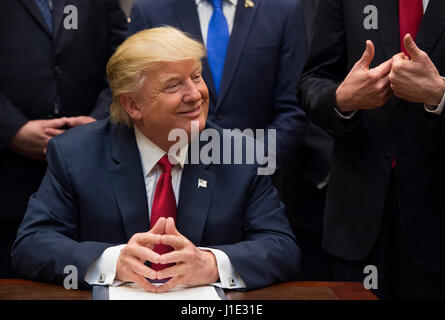 Washington, USA. 19th Apr, 2017. United States President Donald Trump listens after signing the S. 544 the Veterans Choice Program Extension and Improvement Act in the Roosevelt Room at the White HoUSAe in Washington, DC on April 19, 2017. Photo: Molly Riley/Consolidated/Pool/dpa/Alamy Live News Stock Photo