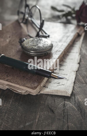 Old vintage diary book on wooden table. Toned photo. Stock Photo