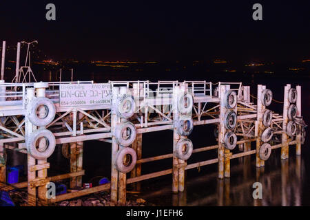 TIBERIAS, ISRAEL - DECEMBER 09, 2015: Night scene of the Yigal Allon Promenade, with a pier and the Sea of Galilee, in Tiberias, Israel Stock Photo
