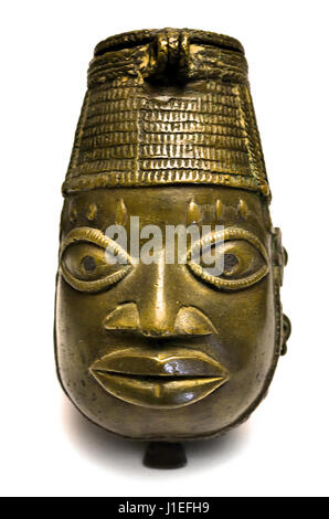 An 18th to 19th-century bronze Ofoe vessel shaped like a stylized human face with an elaborate reticulated headdress, originating from the Kingdom of Benin, Nigeria, shot on a clean white isolation background. Stock Photo