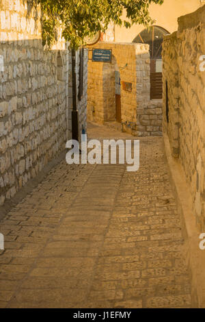 SAFED, ISRAEL - SEPTEMBER 14, 2016: An alley in the Jewish quarter of the old city, with the Abuhav Synagogue sign, in Safed (Tzfat), Israel Stock Photo