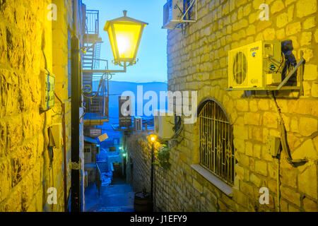 SAFED, ISRAEL - SEPTEMBER 14, 2016: An alley in the Jewish quarter of the old city, with various business signs, in Safed (Tzfat), Israel Stock Photo