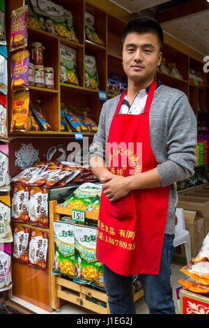 Guizhou Province, China.  Shopkeeper, Souvenir and Gift Shop Area, Yellow Fruit Tree (Huangguoshu) Waterfall Scenic Area. Stock Photo