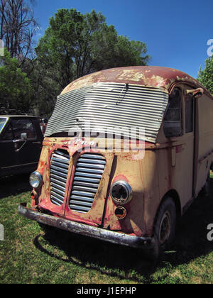 Vintage metro van parked outdoors in a grassy area. Stock Photo