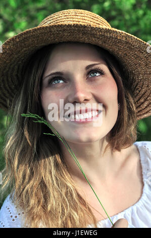 close-up  portrait of a teenage   girl at the meadow in sunny day Stock Photo