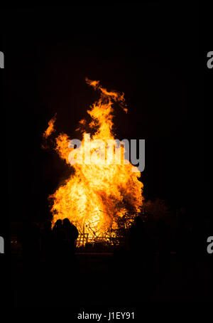 People standing in front of a roaring bonfire as part of the annual Faringdon Fireworks event. Stock Photo