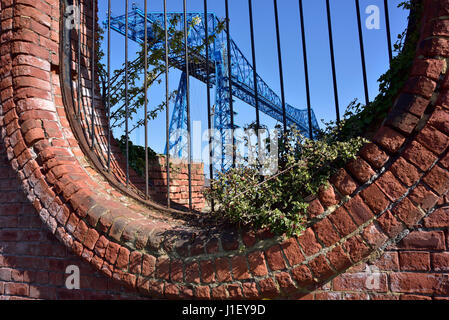 The Transporter Bridge over the River Tees,  Middlesbrough, seen through an oval opening in Vulcan Street Wall Stock Photo