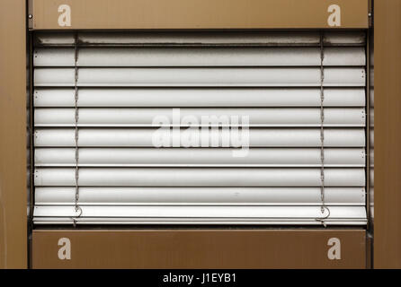 aluminum white blinds on the window Stock Photo