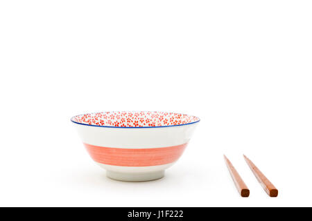 Empty bowl with chopsticks isolated on a white background Stock Photo