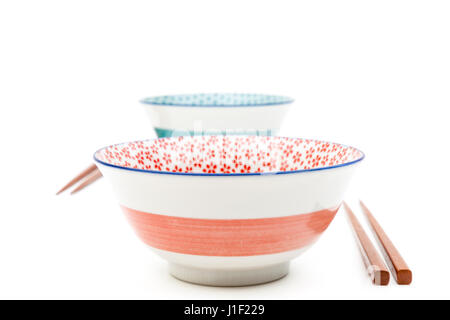 Two empty bowls with chopsticks isolated on a white background Stock Photo