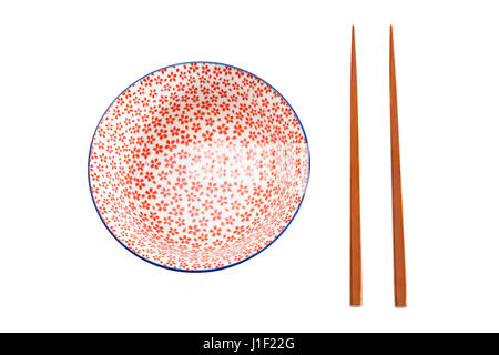 Empty rice bowl with chopsticks viewed from above and isolated on a white background Stock Photo