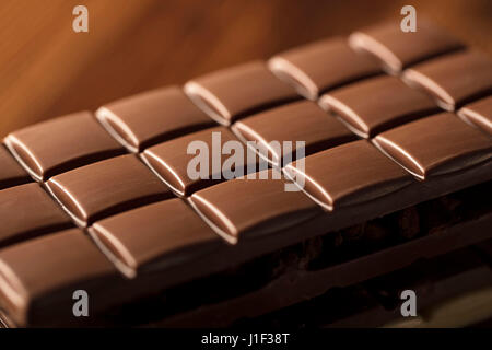 Different nuts in bowls on wooden table. Chocolate. Stock Photo
