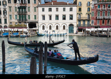 Two gondoliers rowing gondolas on Grand Canal in Venice near Rialto Bridge Stock Photo