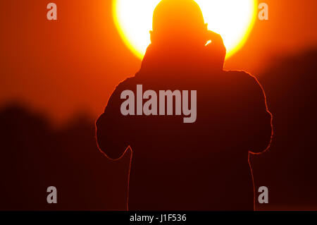 Man taking pictures of the sunrise in Rio de Janeiro, Brazil Stock Photo