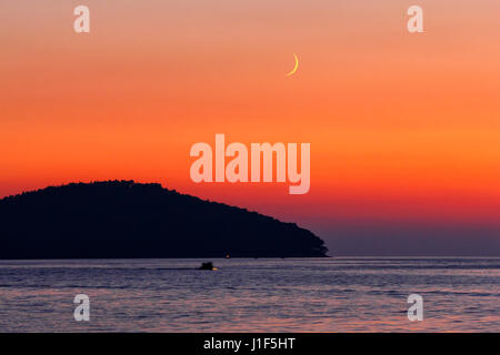 Sunset on island Korcula in Croatia with crescent moon on the sky Stock Photo