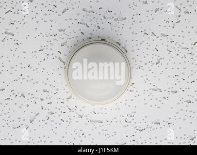 Smoke detector part of fire alarm system install under ceiling. Stock Photo