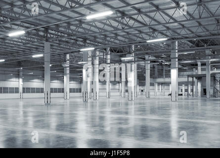 Empty factory building or warehouse building with concrete floor for background. Stock Photo