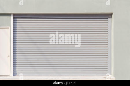 Shutter door or roller door outside factory building. Stock Photo