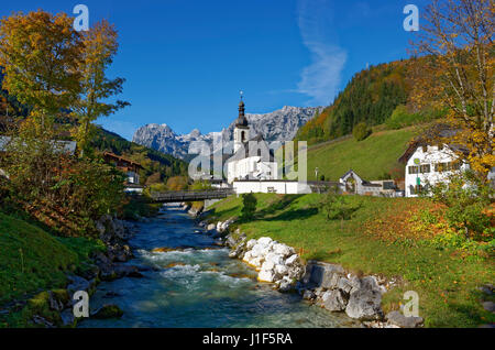 Parish church St. Sebastian in autumn, Ramsauer Ache, in the back Reiteralpe, Ramsau near Berchtesgaden, Berchtesgaden Stock Photo