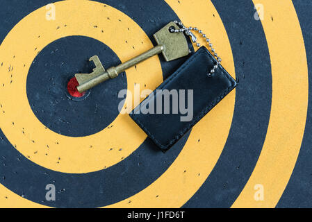 old key to success concept with blank tag over red target on dartboard Stock Photo