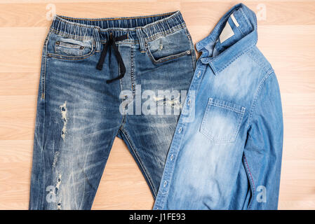 Closeup of torn old blue jeans background. texture of ripped damaged  destroyed denim jeans. hole and scuffs on jeans between legs. repair by  sewing ma Stock Photo - Alamy